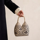 Canastos Pajaros handwoven Colombian basket bag, held in hand