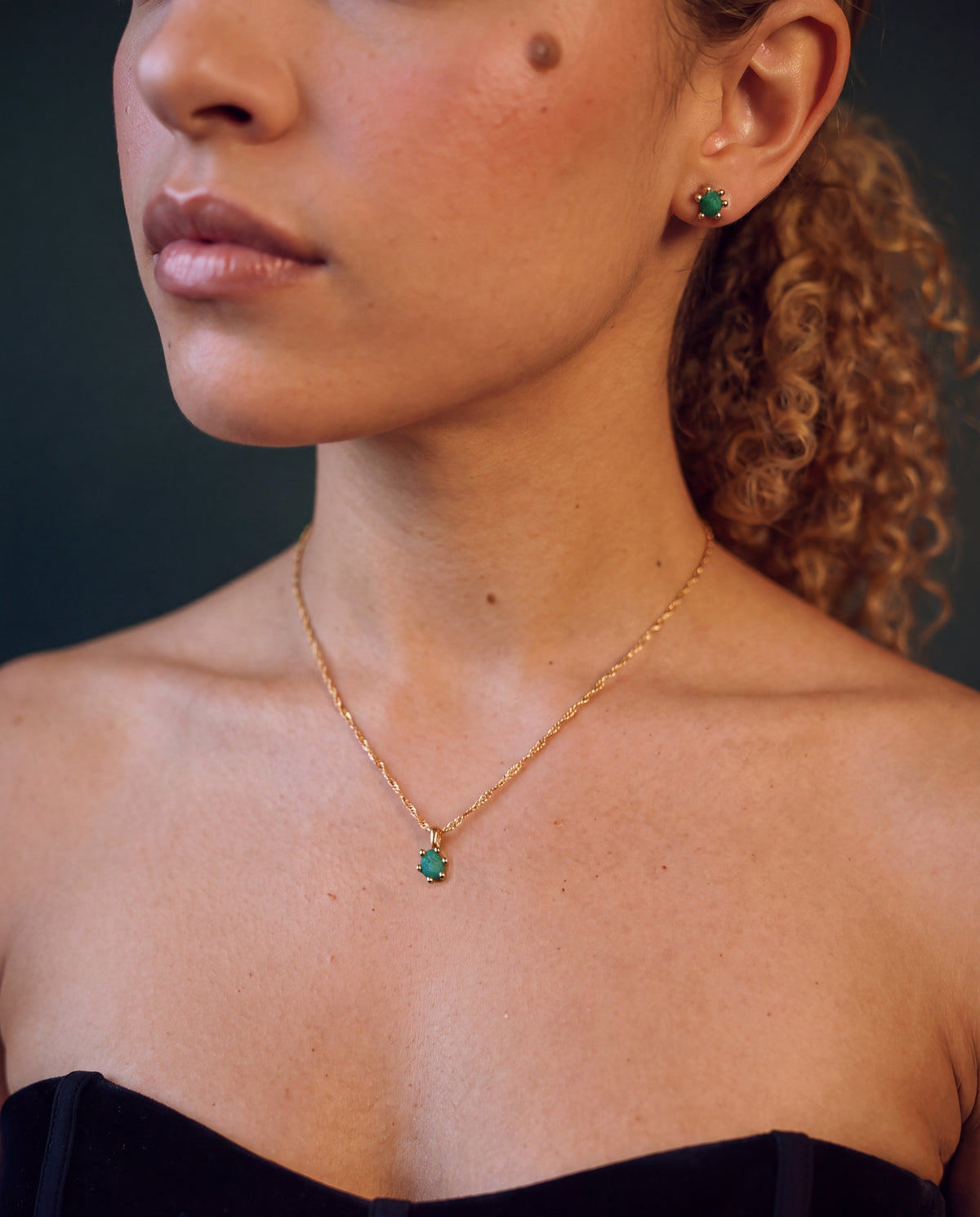 Raw emerald necklace and studs worn together