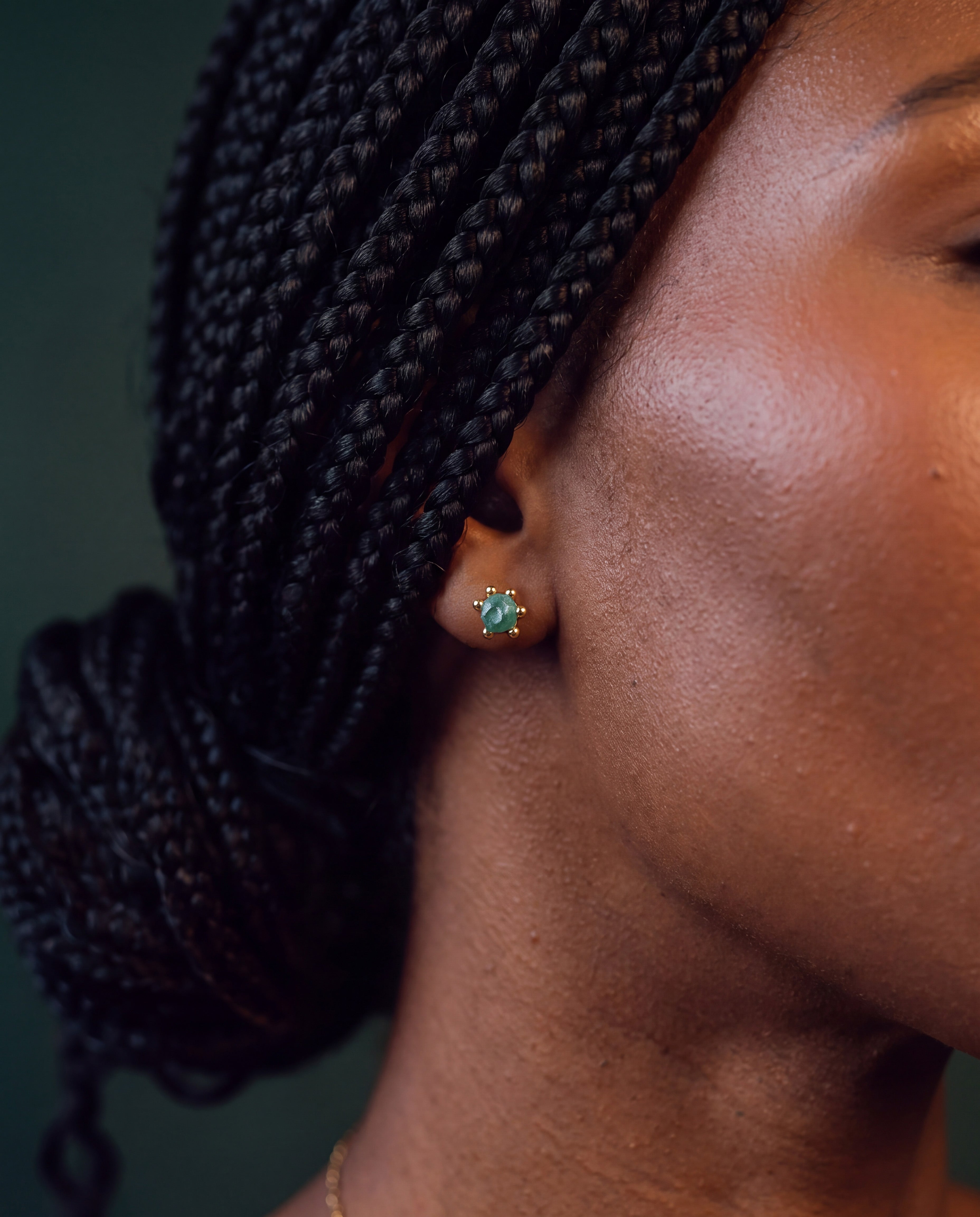 Raw emerald stud earring in 24k gold-plated brass, worn